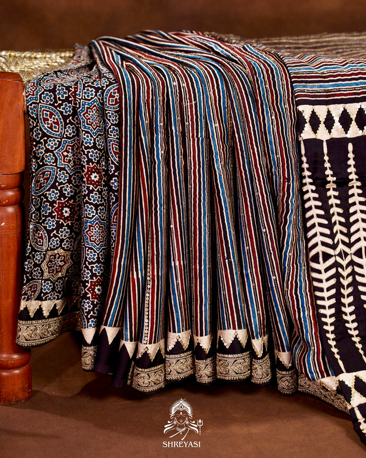 Handloom Pure Modal Silk Ajrakh Hand Block Printed Saree with Natural Dyes, All Over Aari Embroidery & Embroidered Borders