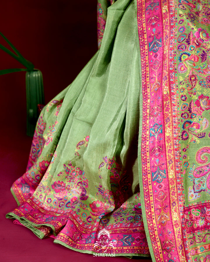 Kashmiri silk saree with multicolour floral and paisley motifs, woven border and pallu, paired with a floral blouse