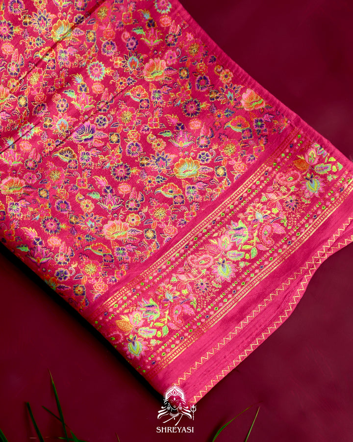 Kashmiri silk saree with multicolour floral and paisley motifs, woven border and pallu, paired with a floral blouse