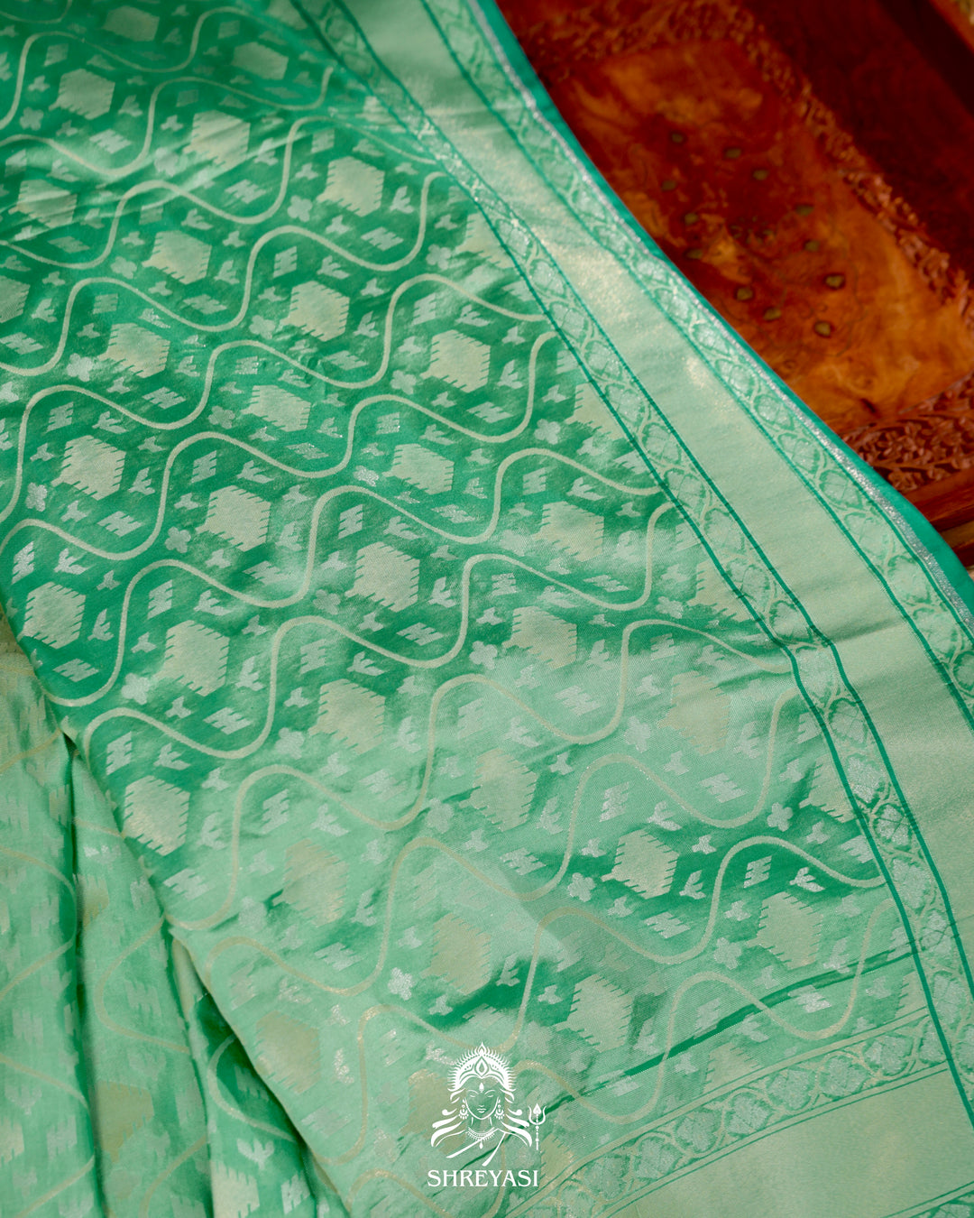 Banarasi Ektara silk saree in soft green with jamdani-style cutwork motifs and subtle woven border