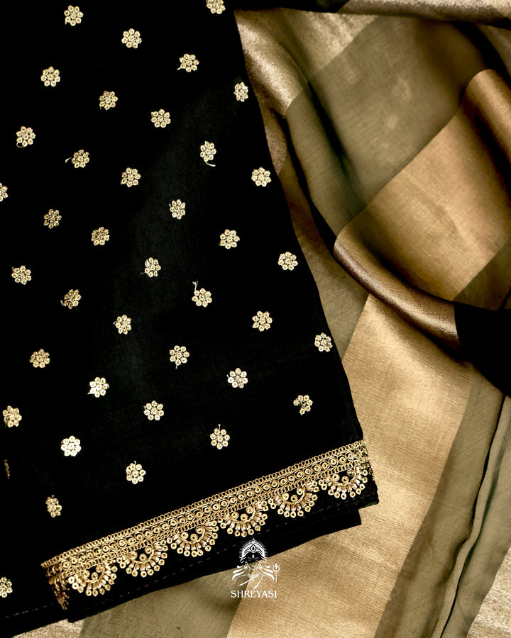 Organza silk saree with broad woven zari stripes, scalloped edges, ornate metallic borders, and a coordinating blouse