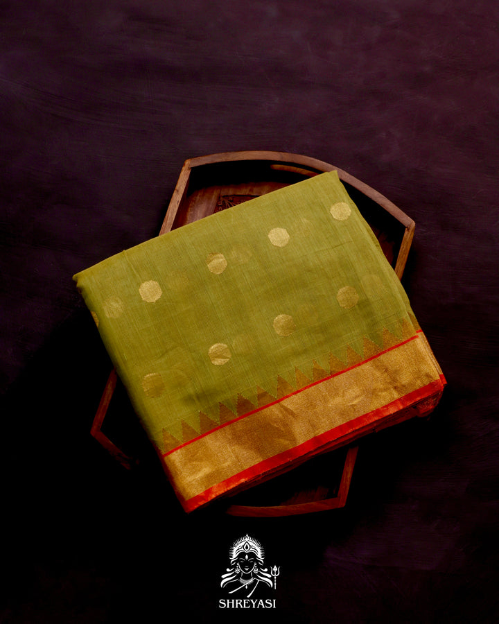 Ponduru Khadi Jamdani saree in olive green with handwoven jamdani motifs and contrast orange border