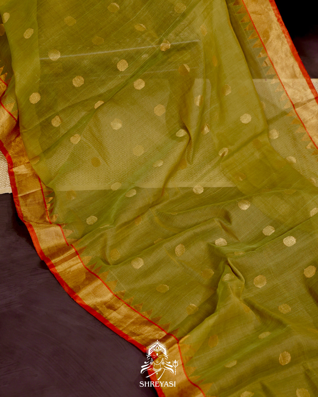Ponduru Khadi Jamdani saree in olive green with handwoven jamdani motifs and contrast orange border