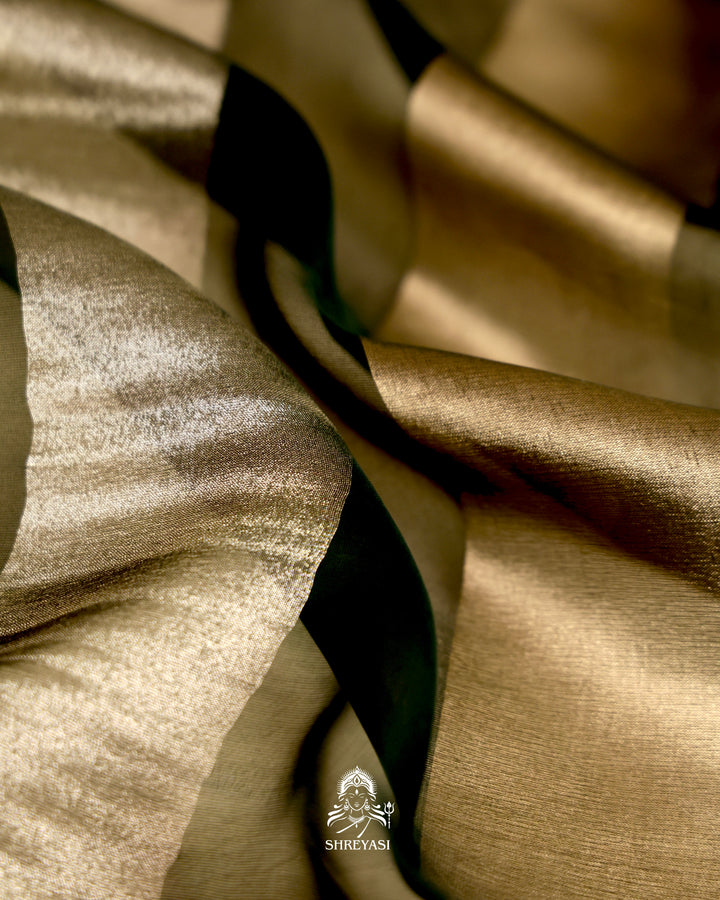 Organza silk saree with broad woven zari stripes, scalloped edges, ornate metallic borders, and a coordinating blouse