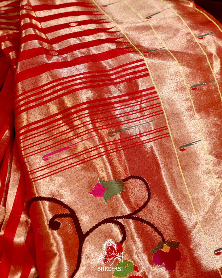 Handloom pure Paithani silk saree with woven zari stripes, delicate bhutis, and traditional Paithani motif designer pallu in vibrant hues