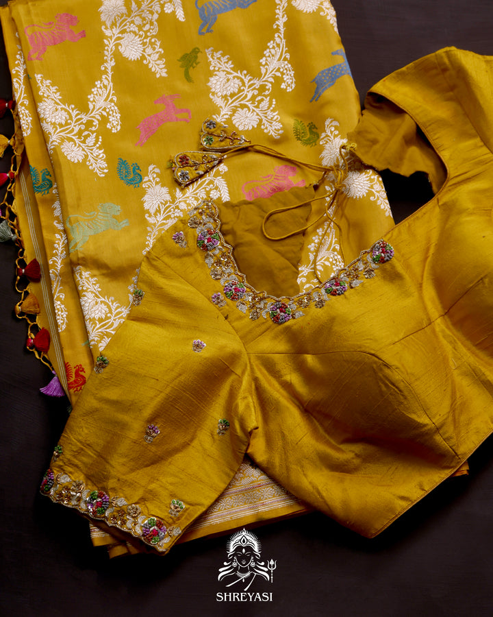 Banarasi Ektara silk saree in marigold yellow with kadhwa meenakari animal motifs and full zari border