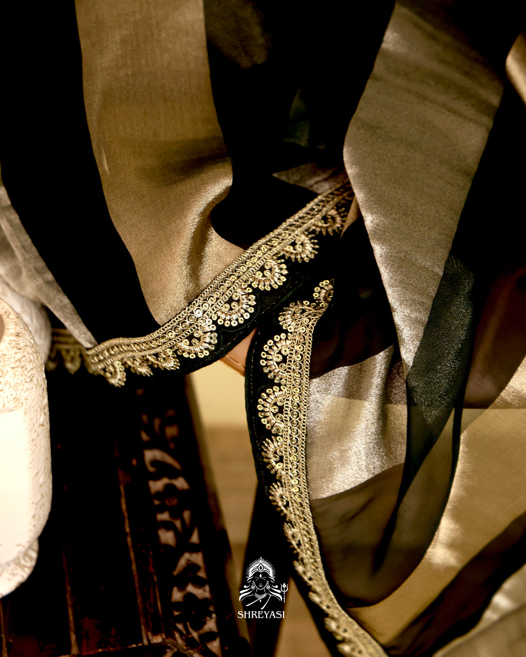 Organza silk saree with broad woven zari stripes, scalloped edges, ornate metallic borders, and a coordinating blouse