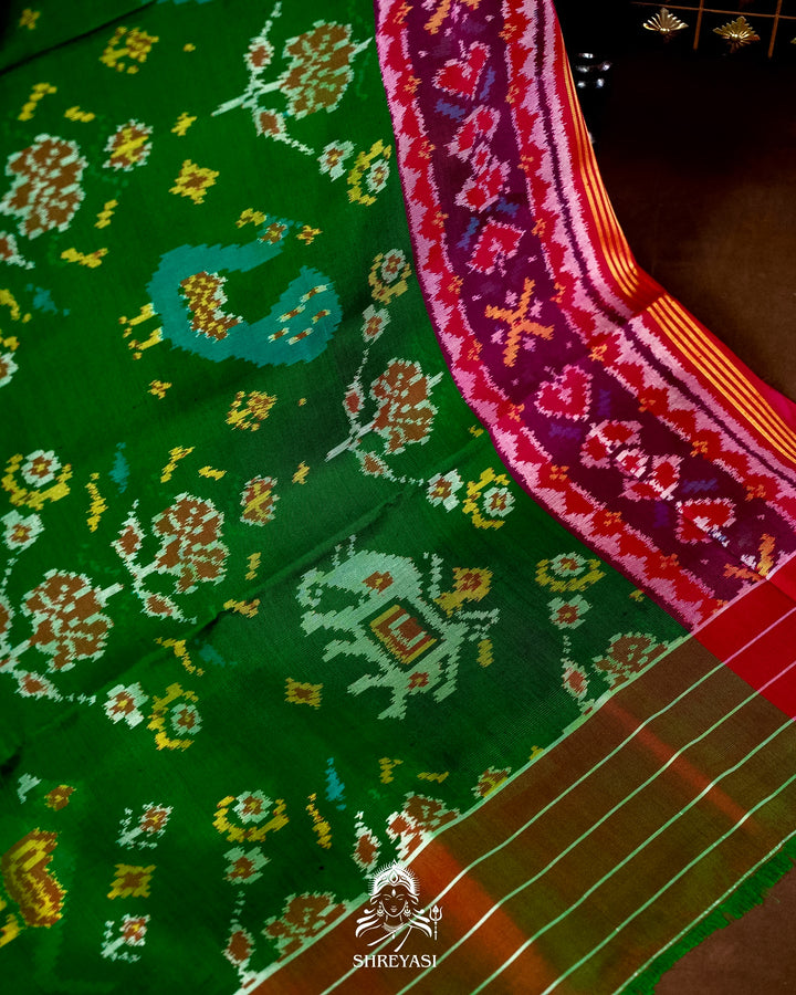 Handloom Pure Rajkot Patola Silk Saree in Emerald Green with Animal & Floral Ikat Motifs