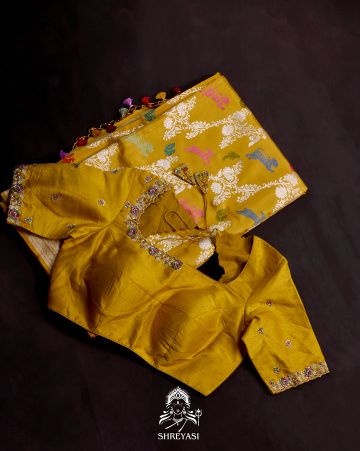 Banarasi Ektara silk saree in marigold yellow with kadhwa meenakari animal motifs and full zari border