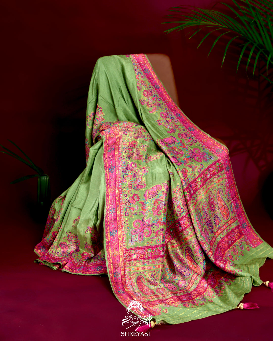 Kashmiri silk saree with multicolour floral and paisley motifs, woven border and pallu, paired with a floral blouse