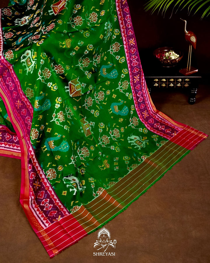 Handloom Pure Rajkot Patola Silk Saree in Emerald Green with Animal & Floral Ikat Motifs