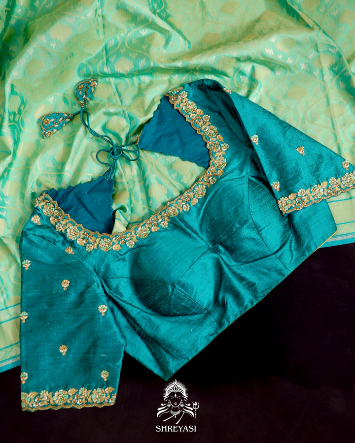 Banarasi Ektara silk saree in soft green with jamdani-style cutwork motifs and subtle woven border
