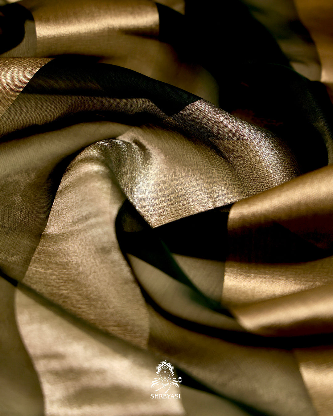 Organza silk saree with broad woven zari stripes, scalloped edges, ornate metallic borders, and a coordinating blouse