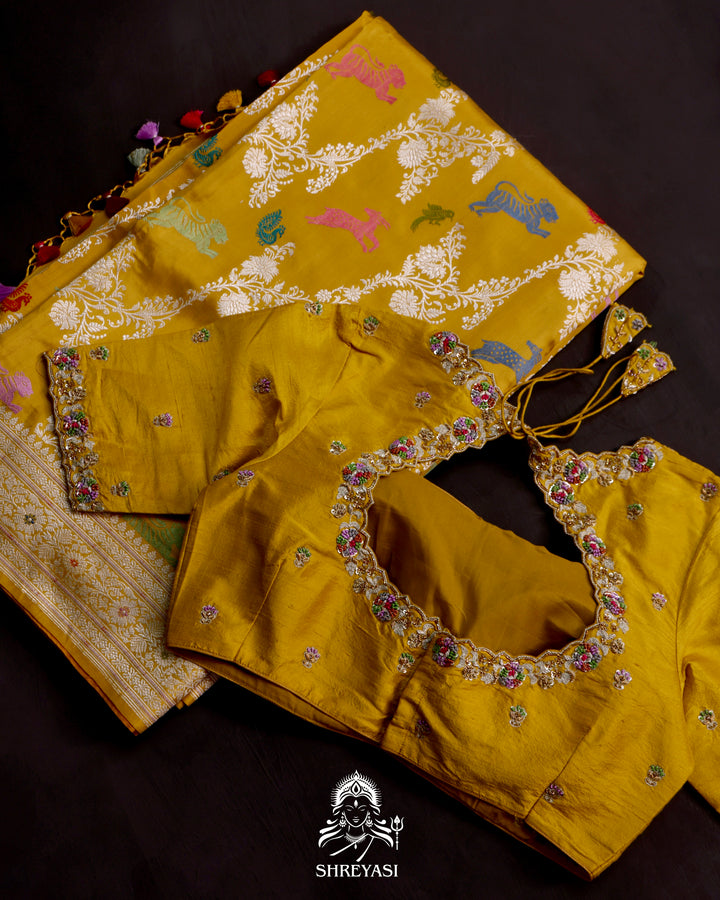 Banarasi Ektara silk saree in marigold yellow with kadhwa meenakari animal motifs and full zari border