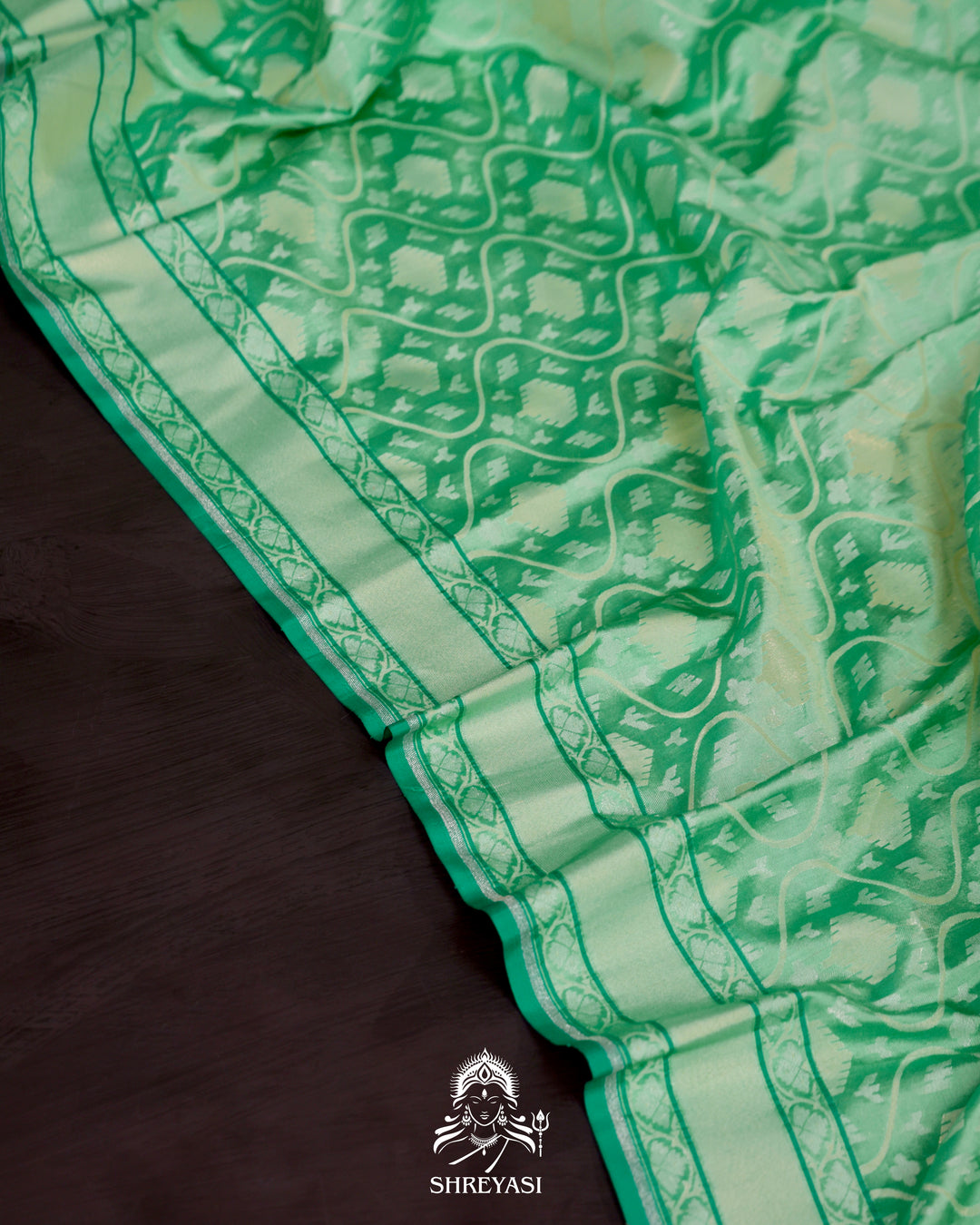 Banarasi Ektara silk saree in soft green with jamdani-style cutwork motifs and subtle woven border