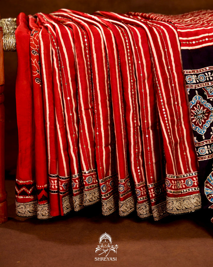 Handloom Pure Modal Silk Ajrakh Hand Block Printed Saree with Natural Dyes, All Over Aari Embroidery & Embroidered Borders