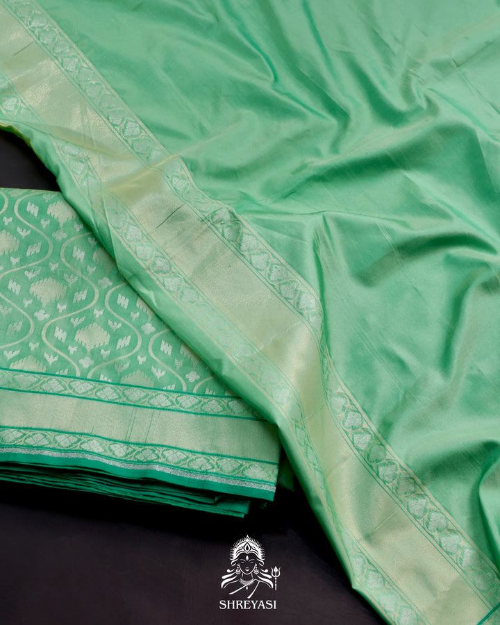 Banarasi Ektara silk saree in soft green with jamdani-style cutwork motifs and subtle woven border