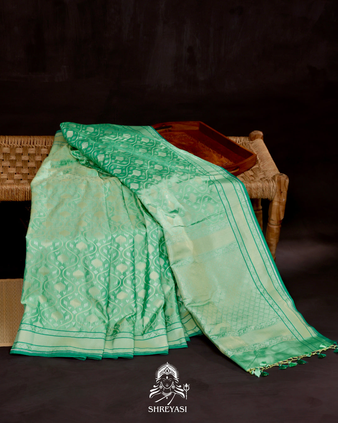 Banarasi Ektara silk saree in soft green with jamdani-style cutwork motifs and subtle woven border