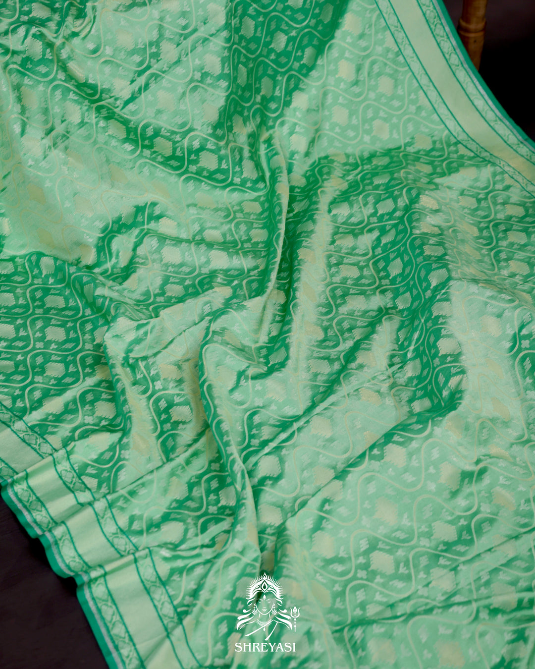 Banarasi Ektara silk saree in soft green with jamdani-style cutwork motifs and subtle woven border