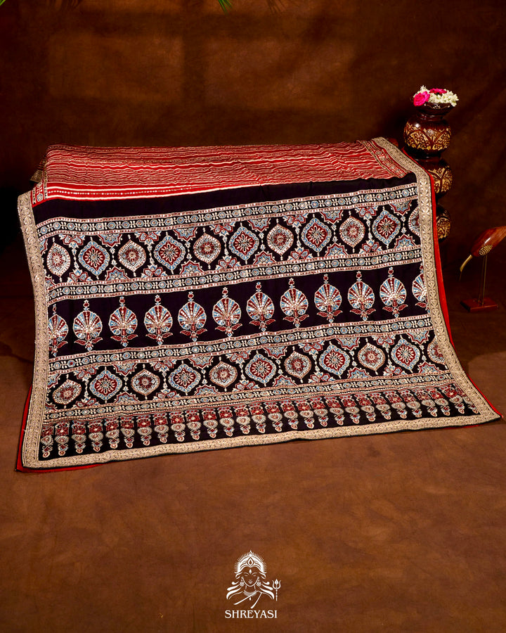 Handloom Pure Modal Silk Ajrakh Hand Block Printed Saree with Natural Dyes, All Over Aari Embroidery & Embroidered Borders