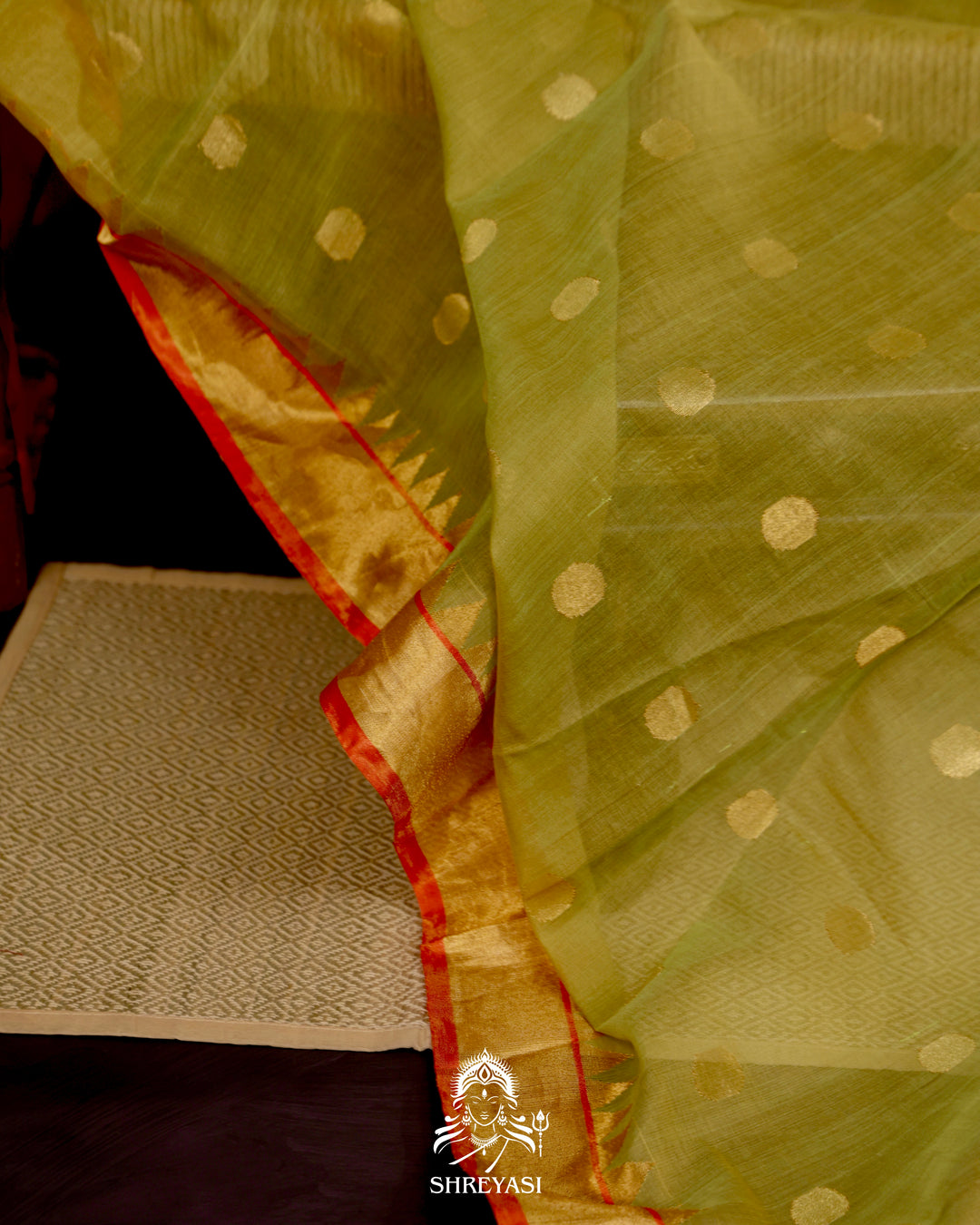 Ponduru Khadi Jamdani saree in olive green with handwoven jamdani motifs and contrast orange border