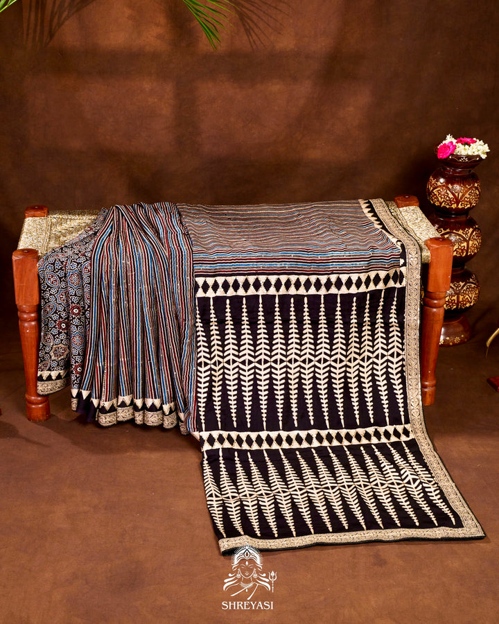 Handloom Pure Modal Silk Ajrakh Hand Block Printed Saree with Natural Dyes, All Over Aari Embroidery & Embroidered Borders