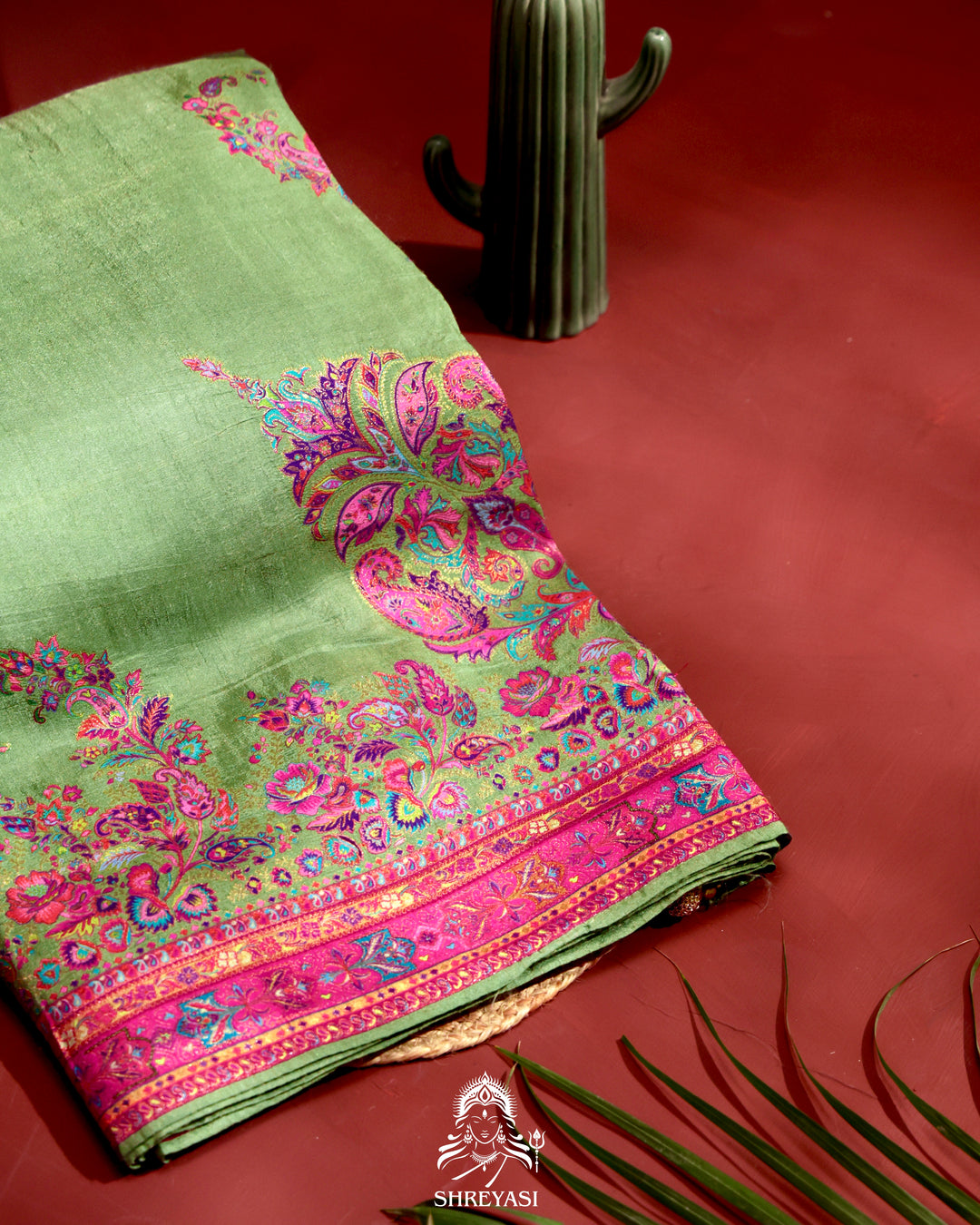 Kashmiri silk saree with multicolour floral and paisley motifs, woven border and pallu, paired with a floral blouse