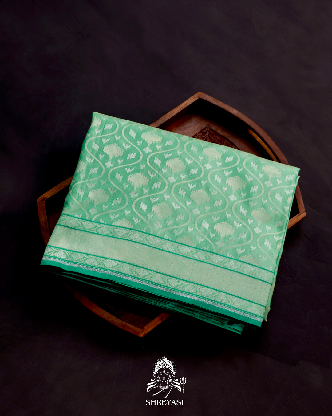 Banarasi Ektara silk saree in soft green with jamdani-style cutwork motifs and subtle woven border